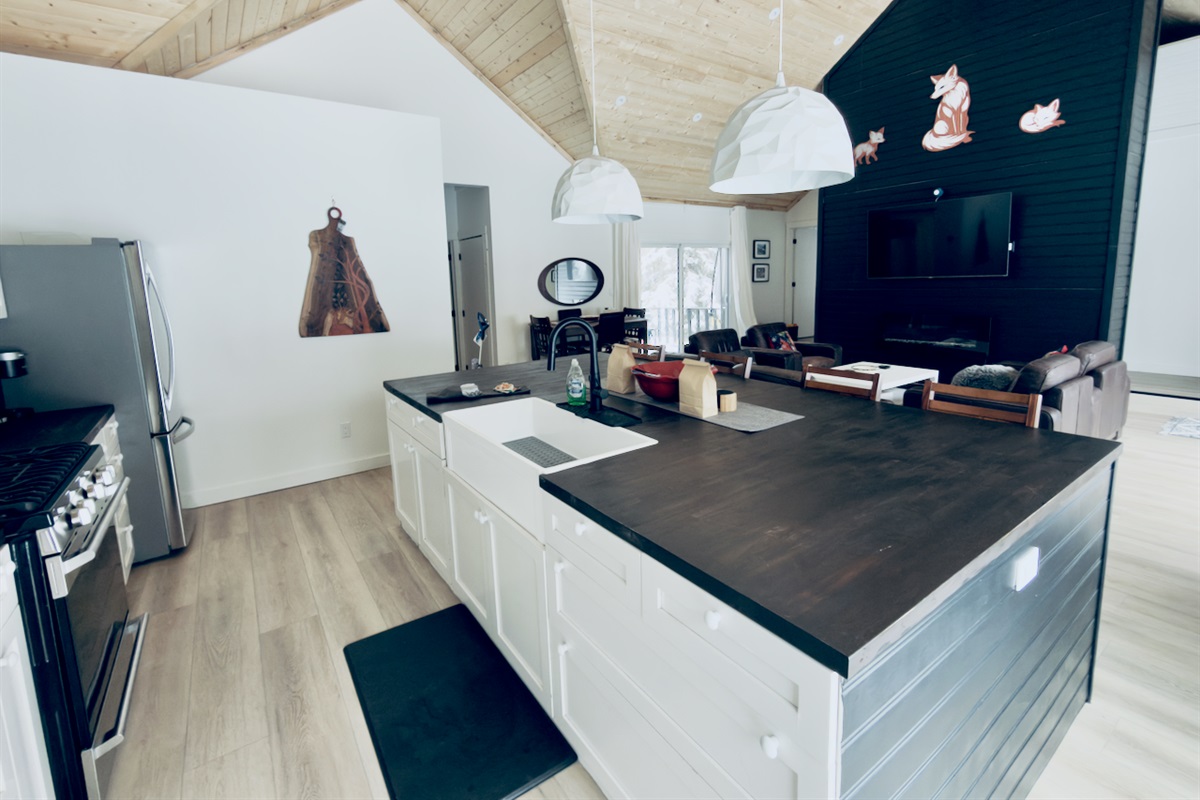 Fully equipped kitchen with stainless steel appliances and prep island