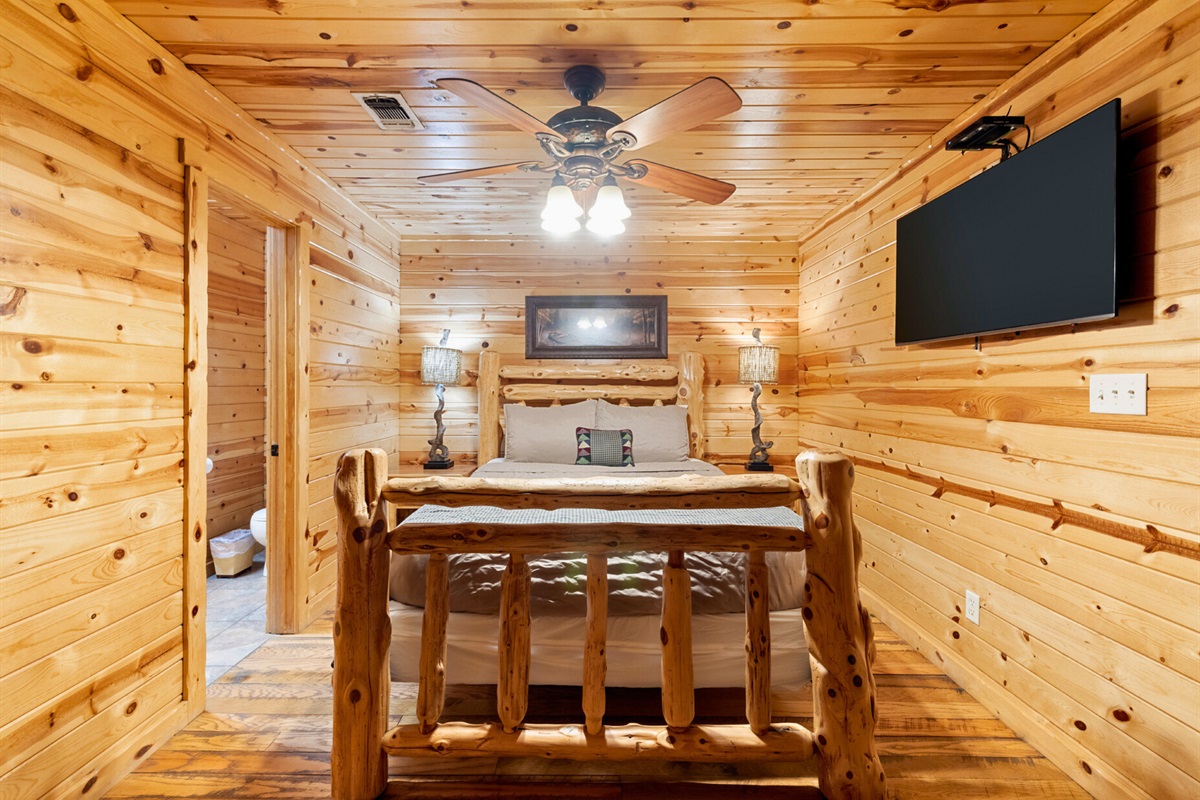 Bedroom 3 alternate view with log bed and TV.