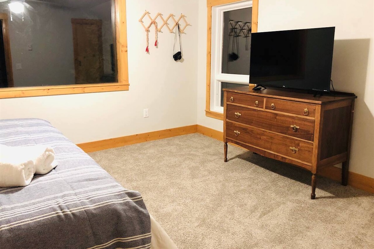 Enjoy watching TV from the comfort of your bed in the primary bedroom.