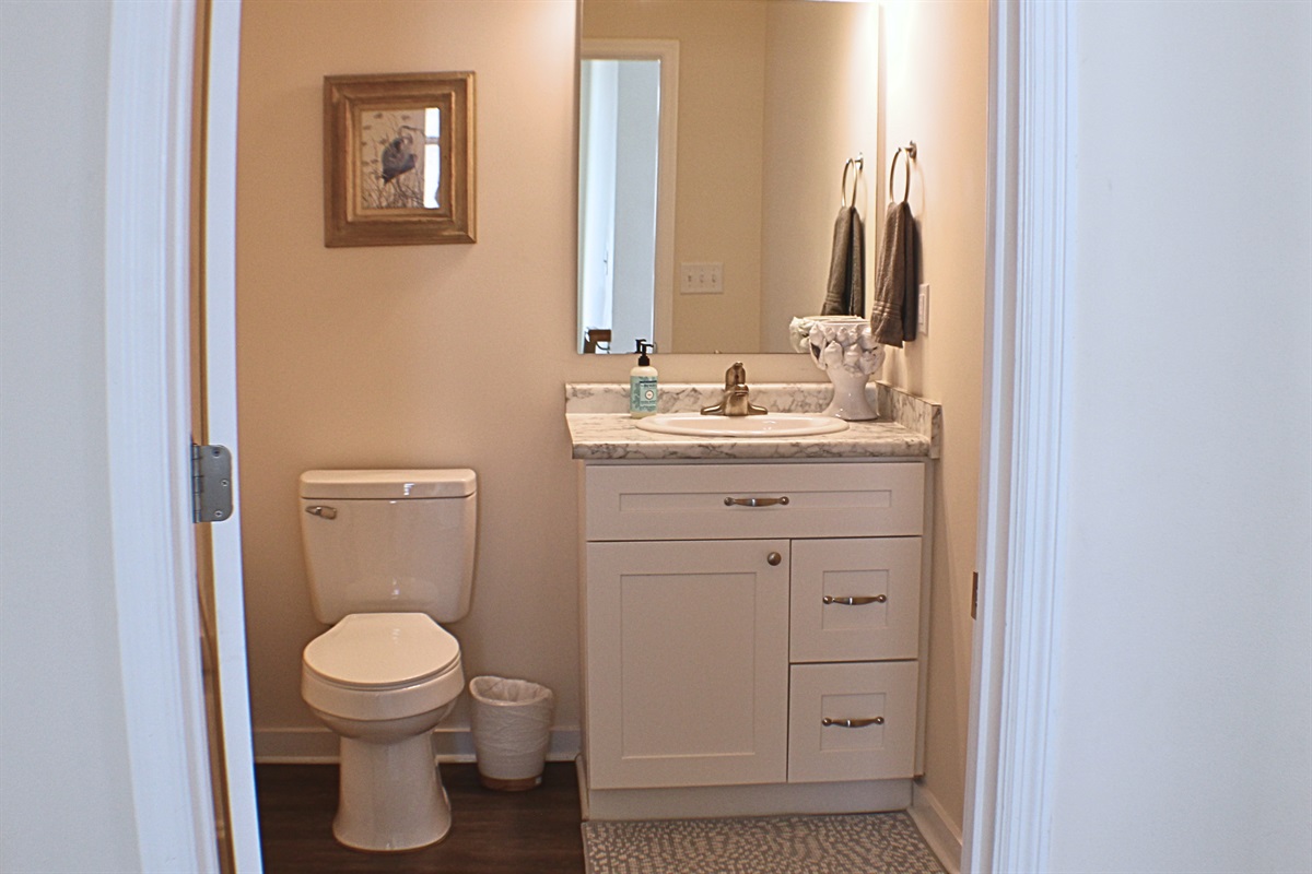 Half Bathroom: Bright and airy, featuring elegant fixtures and stylish decor for your convenience!