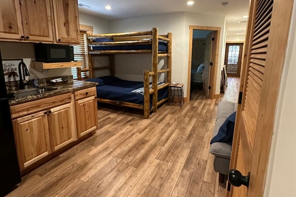 Lower level of the cabin with bunk bed & sofa
This area also has a sink, fridge, & cabinet space.