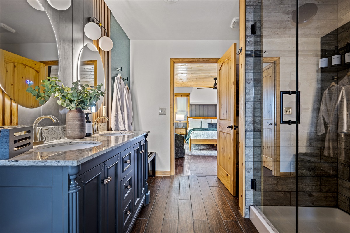 Refresh in the en-suite bathroom's spacious walk-in shower, featuring two shower heads