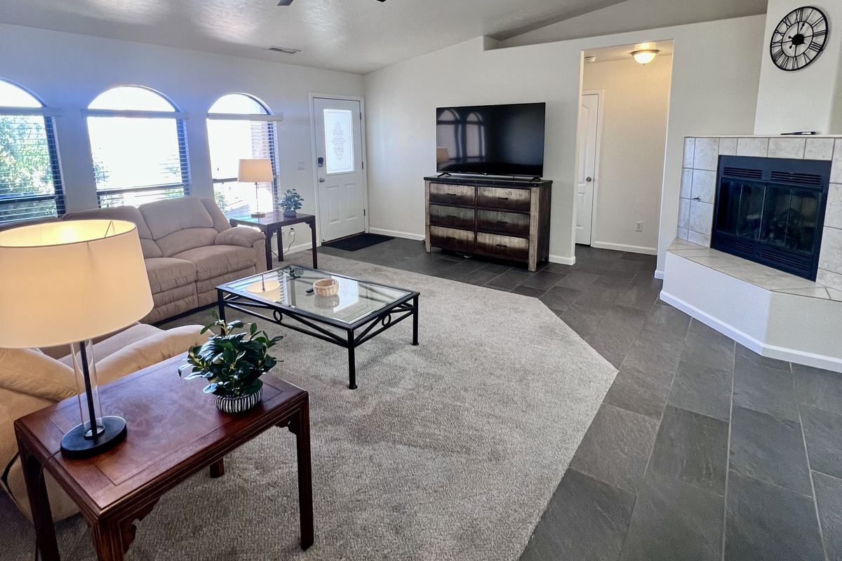 Experience true relaxation in the inviting living room, bathed in natural light. Where spaciousness and comfort reign supreme. Enjoy the gas fireplace for instant ambiance and warmth