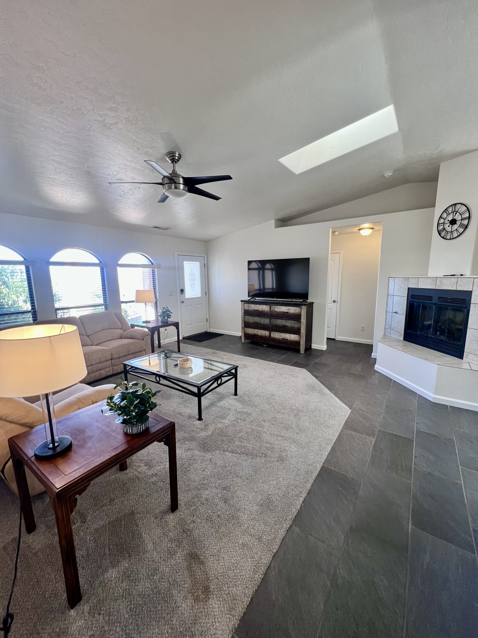 Experience true relaxation in the inviting living room, bathed in natural light. Where spaciousness and comfort reign supreme. Enjoy the gas fireplace for instant ambiance and warmth