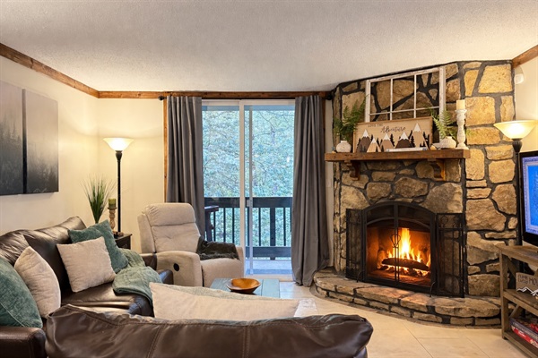 An oversize Italian leather sofa and chair, a cozy woodburning fireplace, a smart tv with all of your favorite streaming services AND a view of the creek below.  This living room will welcome you in for the evening and make you feel right at home!