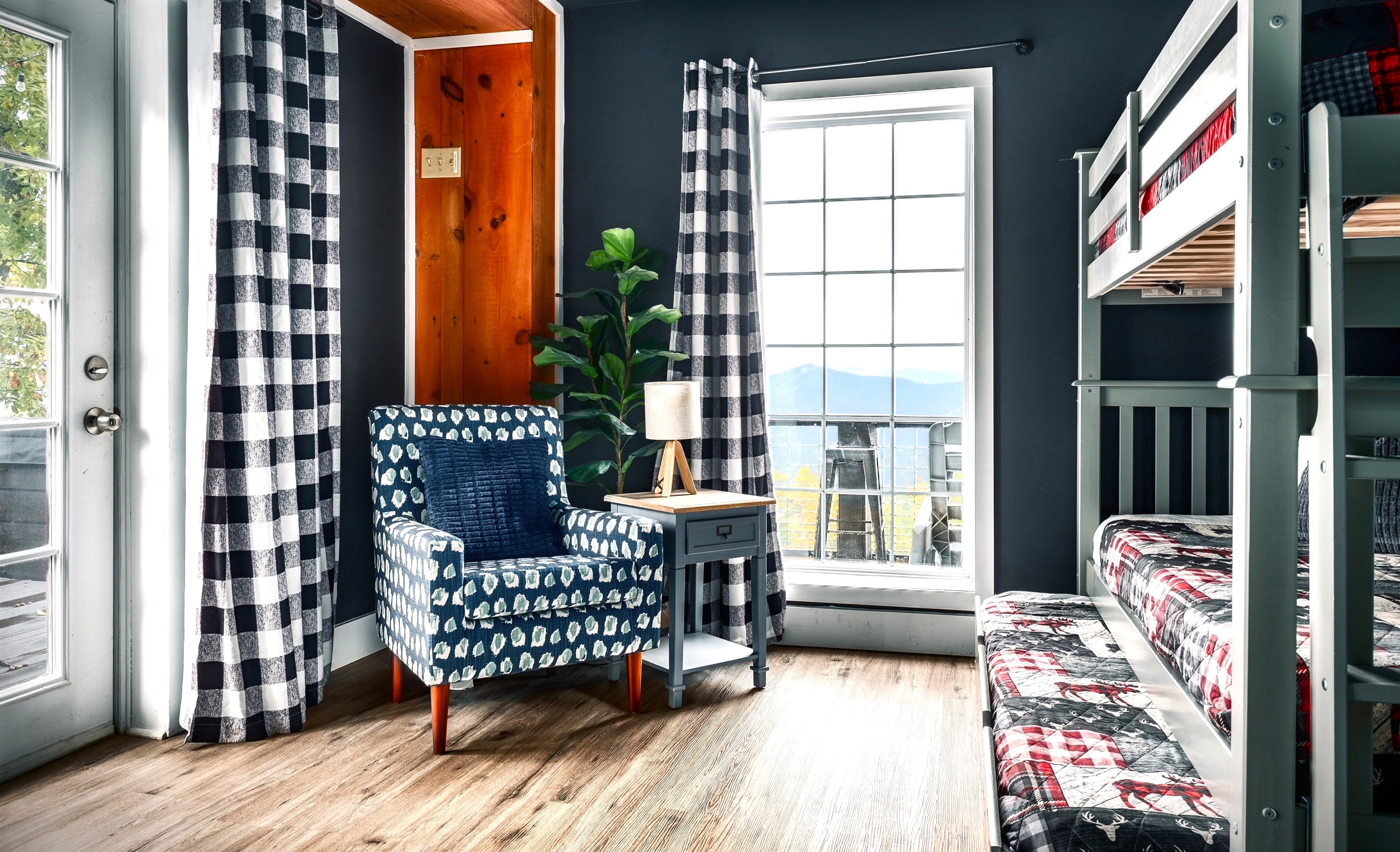 This is a secondary bedroom #1 in the basement with direct access to the hot tub & firepit area. That big window look out straight to the mountain view. Twin size bunk bed and a trundle - Sleeps 3.
