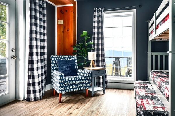 This is a secondary bedroom #1 in the basement with direct access to the hot tub & firepit area. That big window look out straight to the mountain view. Twin size bunk bed and a trundle - Sleeps 3.