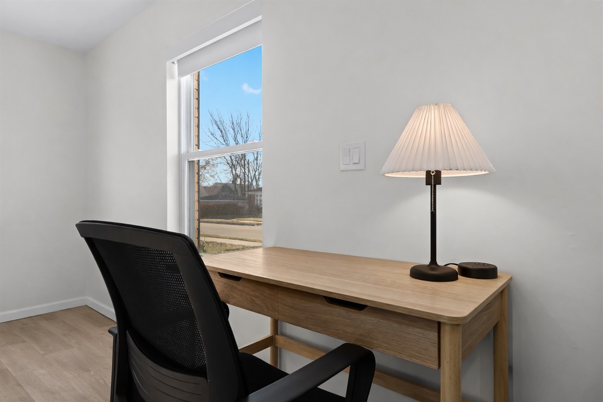 Bright, dedicated workspace with a comfortable desk, task lighting, and natural light—perfect for working remotely or staying productive during your stay.