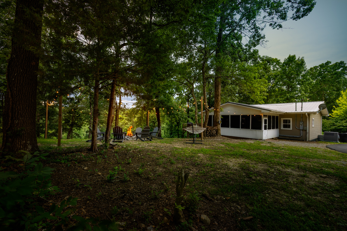 Driftwood Retreat offers a peaceful wooded setting, a roomy yard, and plenty of space for families to spread out.