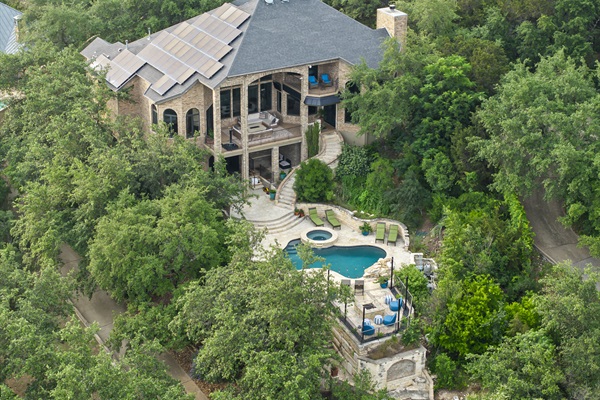 House is situated on a 1+ acre lot surrounded by trees.