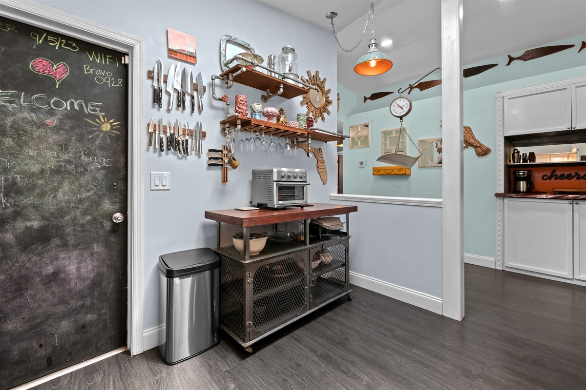 Kitchen back wall, showcasing the appliances and tiki adorned shelves.