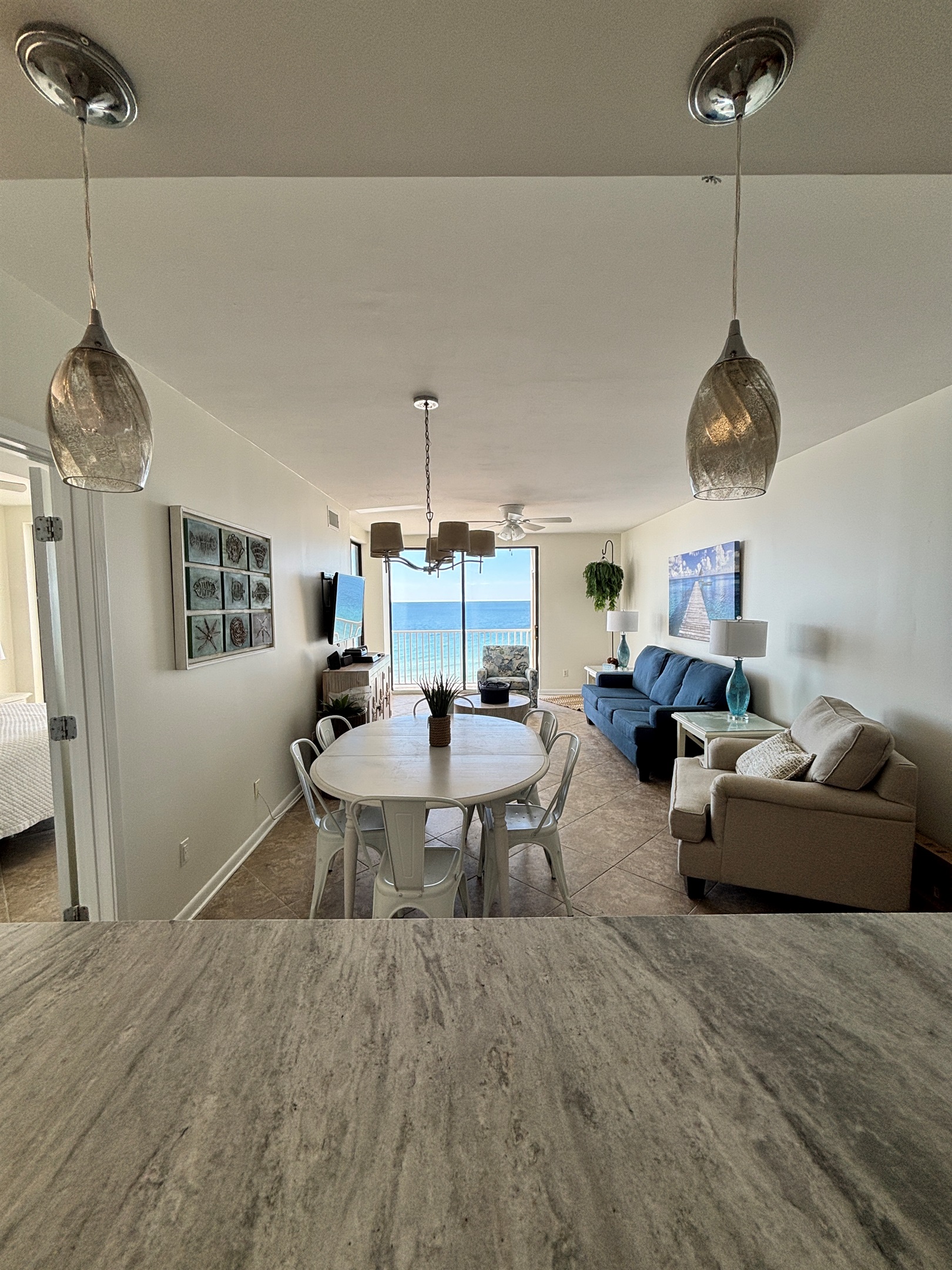 Open living space with comfortable seating and easy access to the beachfront balcony.