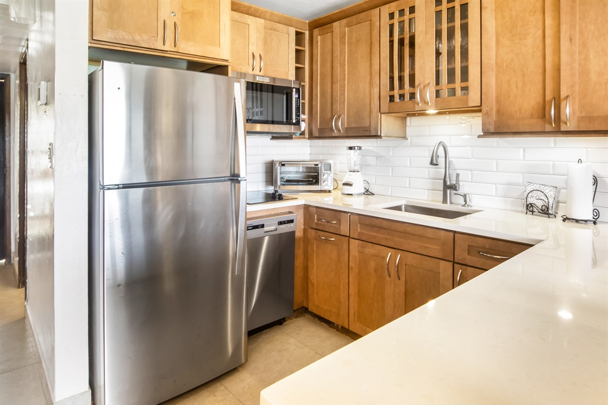 Updated kitchen featuring sleek cabinetry and full-size appliances for all your cooking needs.