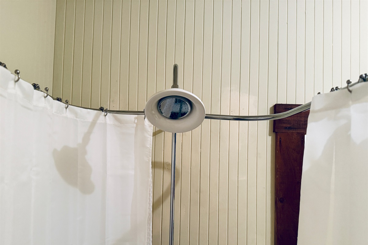 Cozy Rio Nido cabin bath with soaking tub and gentle rainfall shower.