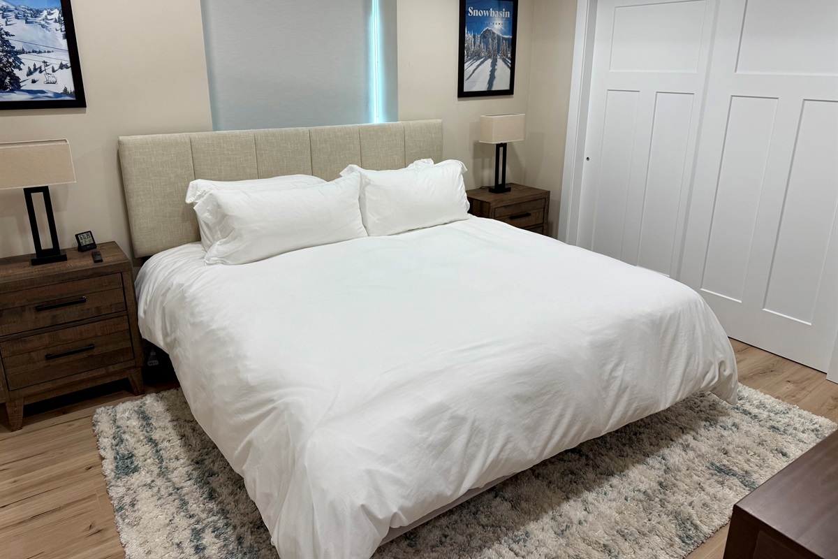 Comfortable lower-level bedroom with soft bedding and peaceful design.