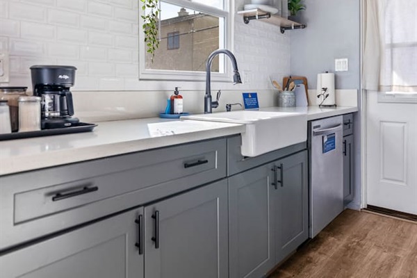 Stylish kitchen featuring a sleek sink and ample drawer storage beneath a beautiful granite countertop. Thoughtful design elements add elegance, creating a functional space that's perfect for cooking and entertaining in comfort and style.