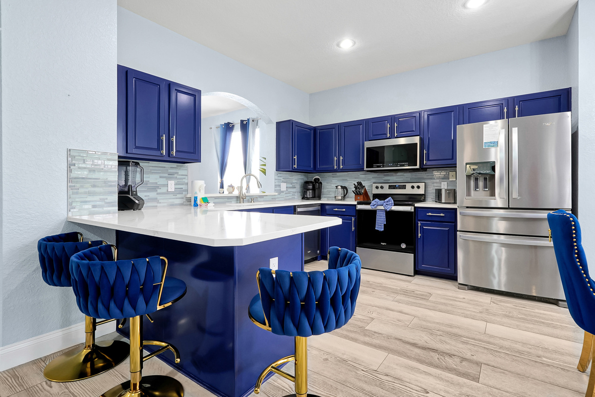 Kitchen with blue cabinets and island seating