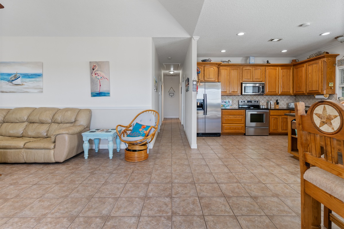 Living room/Kitchen with view of hallway leading to bedrooms