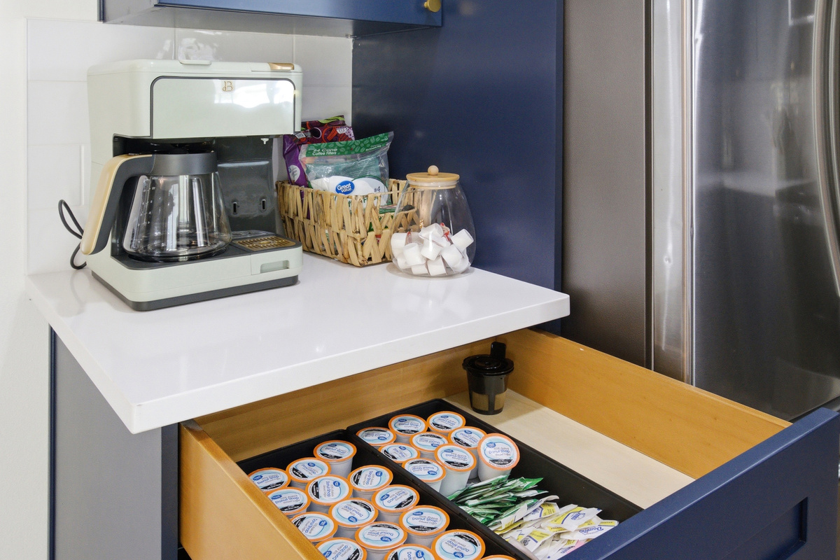 Coffee Station with both Drip Coffee Maker and Keurig setup, K-Cups, sweeteners, and supplies ready in the drawer. Morning brews before game day.
