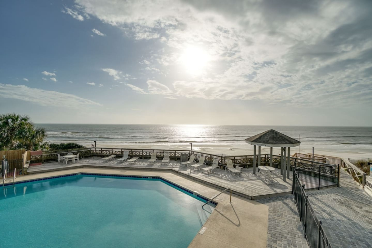 Drop into the beachfront pool steps from the sand &mdash; that gazebo shade is calling your name.
