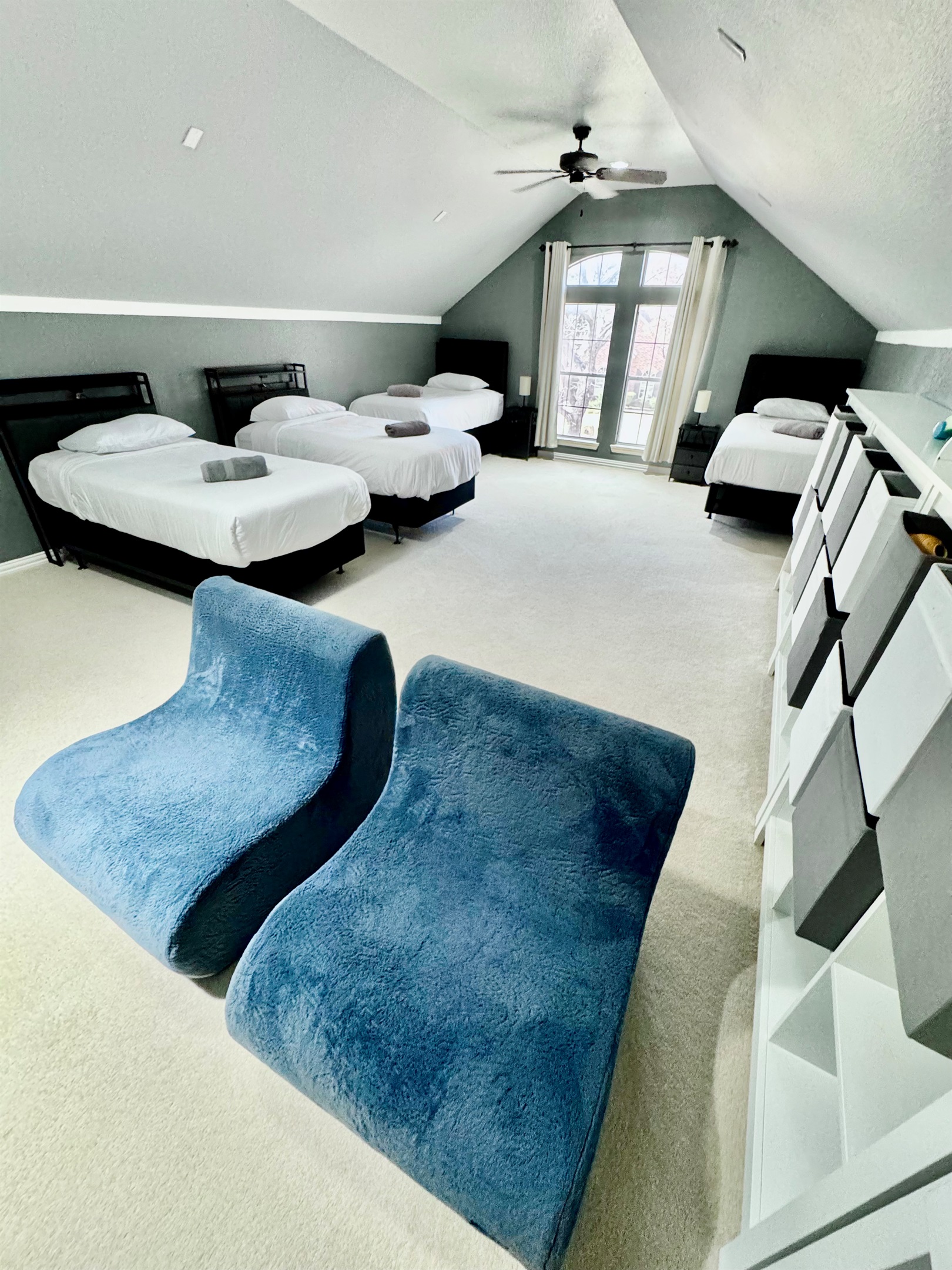 This spacious room has 4 single/twin beds, TV, game room and lounge chairs for great family/friends/work experience!