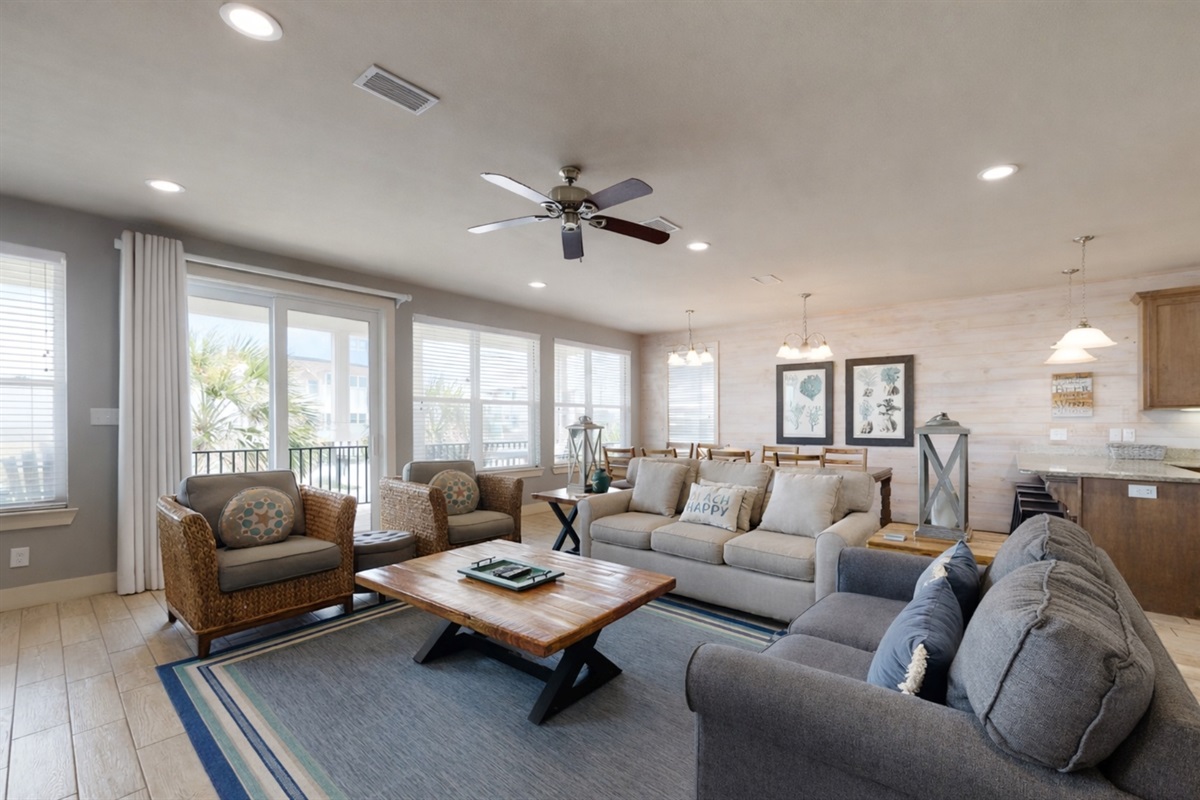 Living room area with plenty of seating and wall mounted Smart TV. Guests must log in to their own streaming services