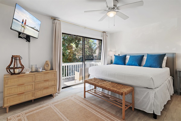 Cozy Coastal Chic Master Bedroom: Unwind in the master bedroom with a luxurious king-sized bed, private bath, and a balcony offering serene views.