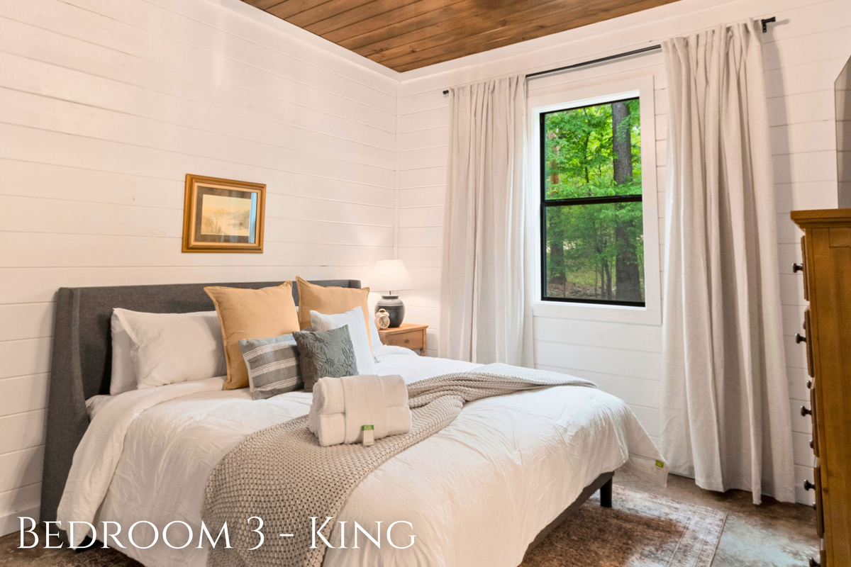 Drift off to sleep in this king-sized bedroom where comfort meets elegance, complete with soft linens and a view that promises peaceful mornings.