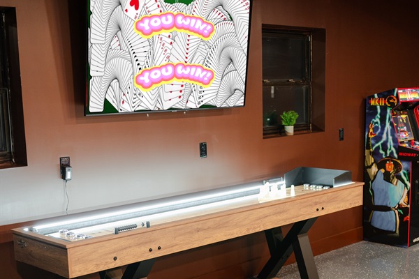The shuffleboard table gives the game room another fun spot for a little friendly competition.