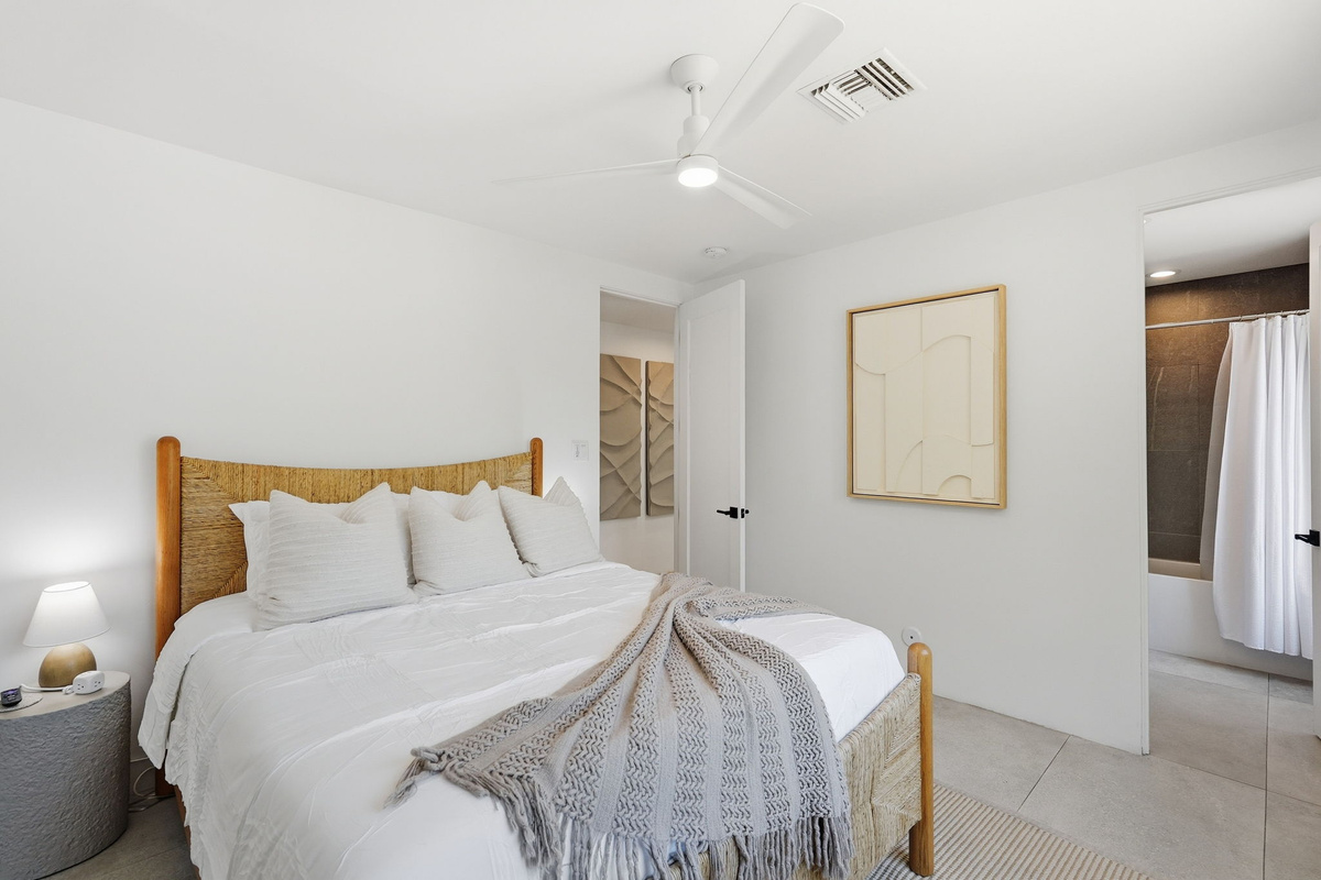 A comfortable luxurious queen bed in Bedroom 3.