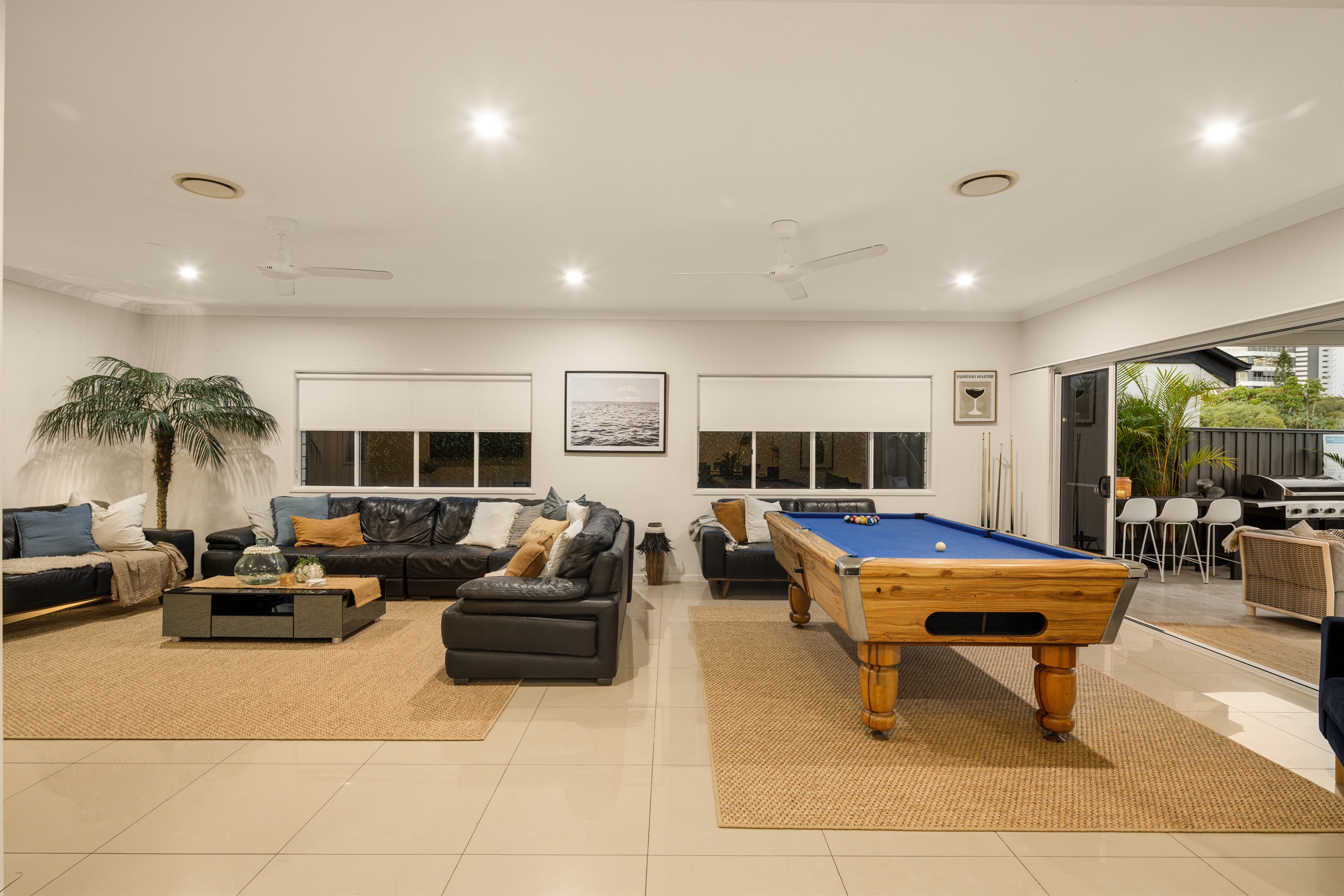 Generous living zone with pool table and multiple seating areas for all ages.