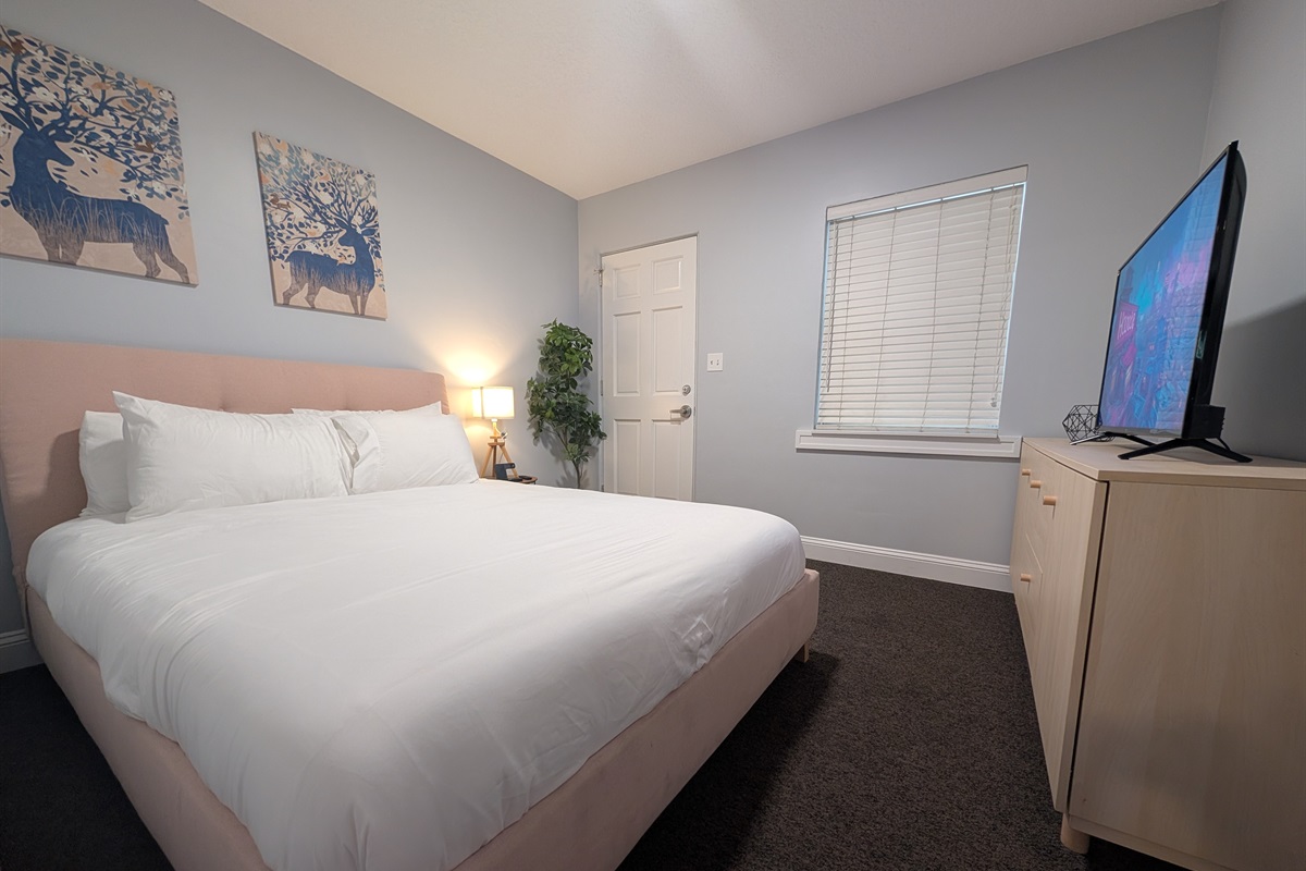 Guest bedroom with queen bed and smart tv