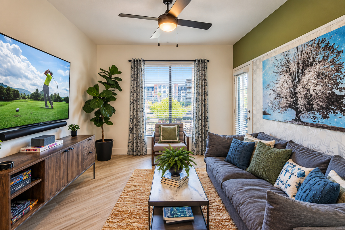 - Relax in a cozy living room with soft lighting and modern decor   - Large windows and greenery create a bright and calming space   - Ideal for movie nights or peaceful downtime after sunny pool days