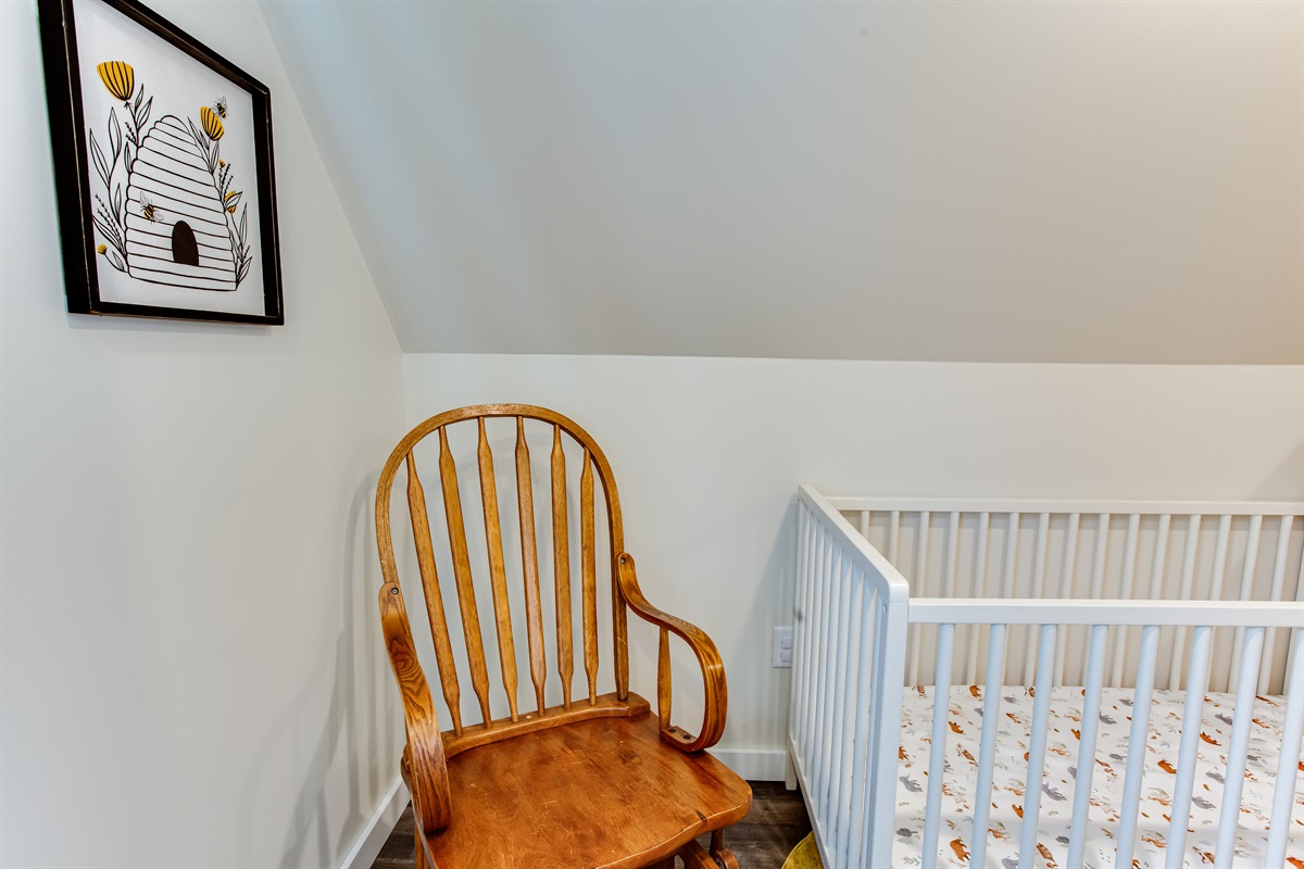Bedroom 3: This spacious walk-in closet features clothing storage, a crib & rocking chair plus a desk.