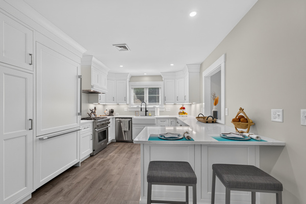Modern open kitchen featuring ample counter space, bar seating, and everything needed to prepare your favorite meals.