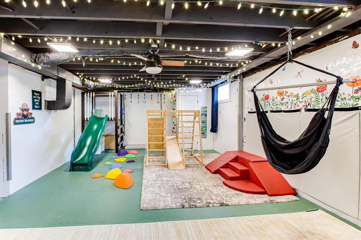 The indoor sensory playground is great for geting kids' energy out in any weather! The other side of the room is a theater area with projector and comfy couches.  Movie nights are so fun here!