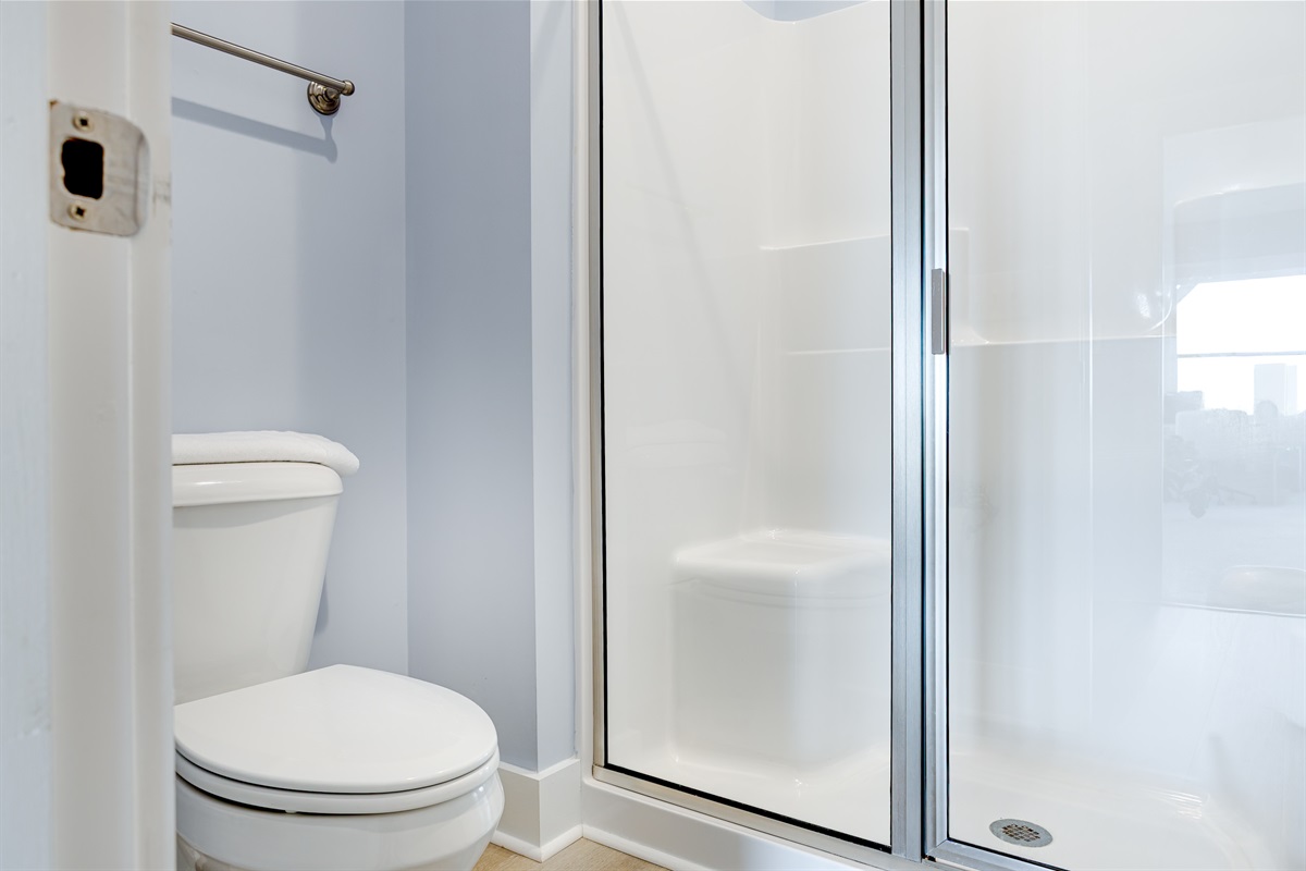 Spacious shower area with simple finishes and easy access from the Master bedroom