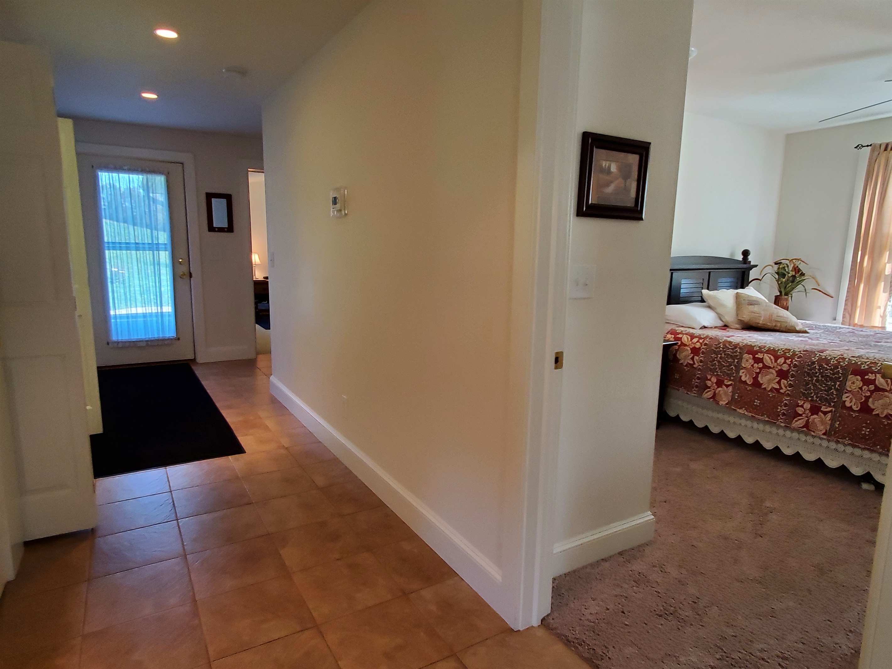 Queen #1 bedroom to the right. Door shown to the left leads to the patio.