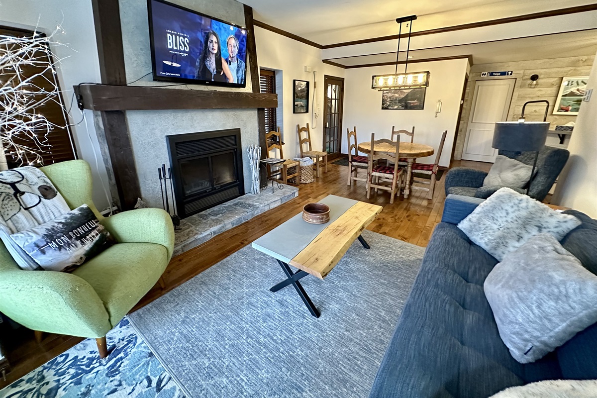 Living area with 50" Smart TV and wood burning fireplace