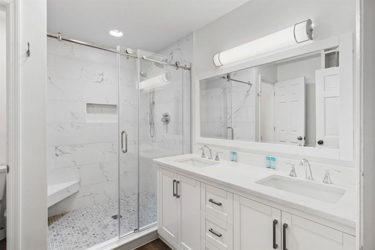 Primary Ensuite Bathroom 1 With Dual Vanities And Walk-In Marble Shower |  IOP Escapes Beach Blessing | 3705 Hartnett Blvd, Isle of Palms, SC