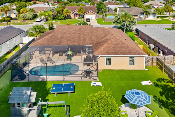 Your private outdoor oasis! 🌴 A breathtaking look at our fully equipped backyard: glowing screened pool, clean artificial turf, 3-hole mini-golf, custom playset, and endless lawn games. The perfect setting for your next getaway!