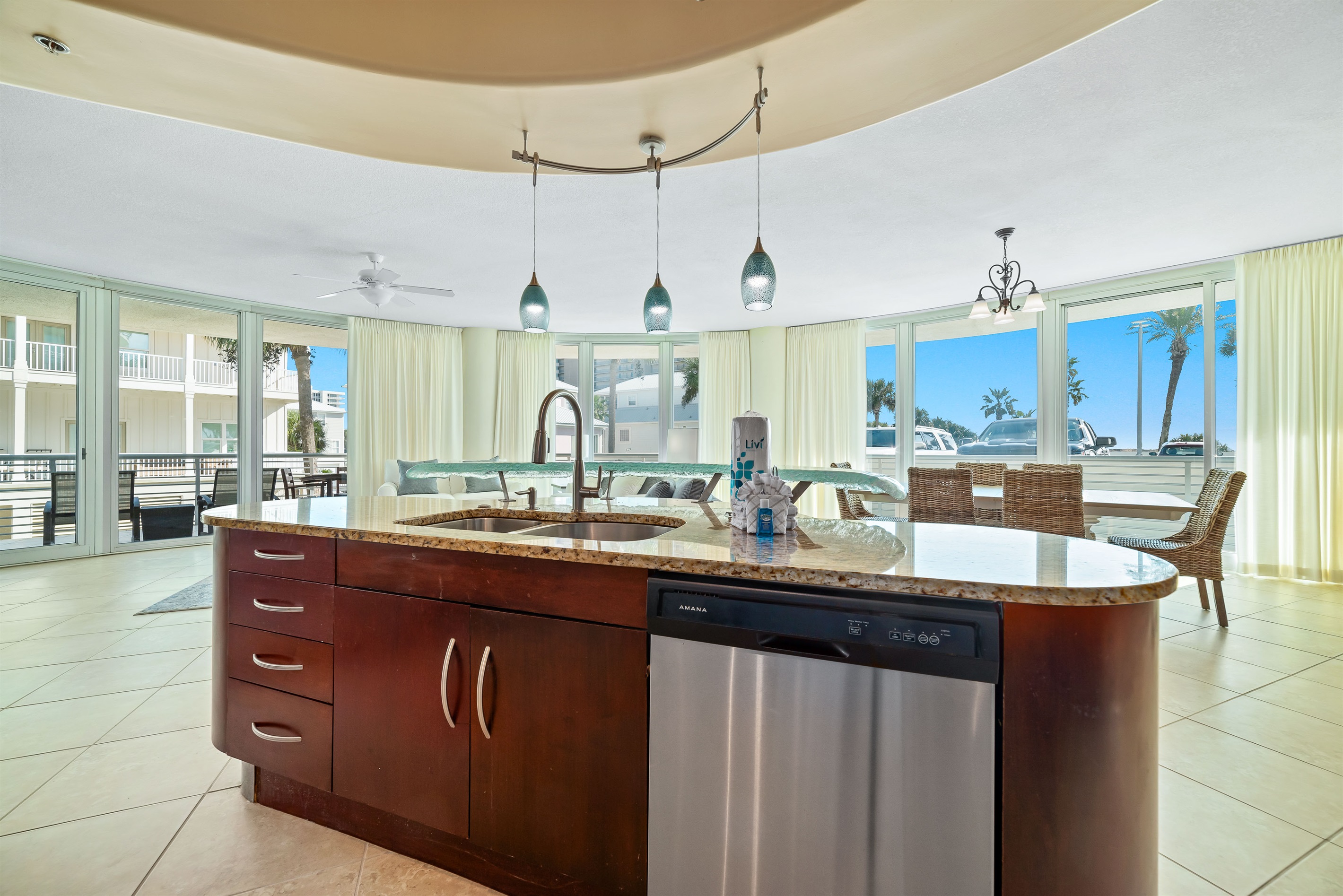 Imagine preparing delicious meals with ease in this well-appointed kitchen, all while staying connected with family and friends in the adjacent living and dining areas. This open-concept design is ideal for a relaxed coastal lifestyle.