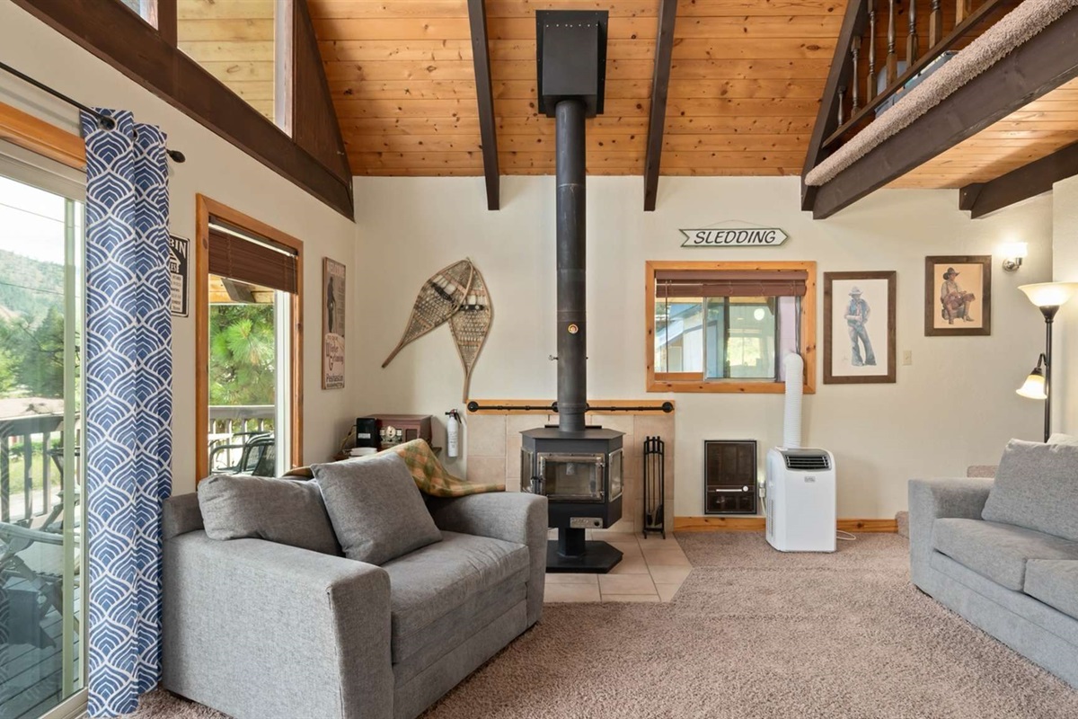 Cozy living area with woodstove — ideal for curling up after a day of adventure.