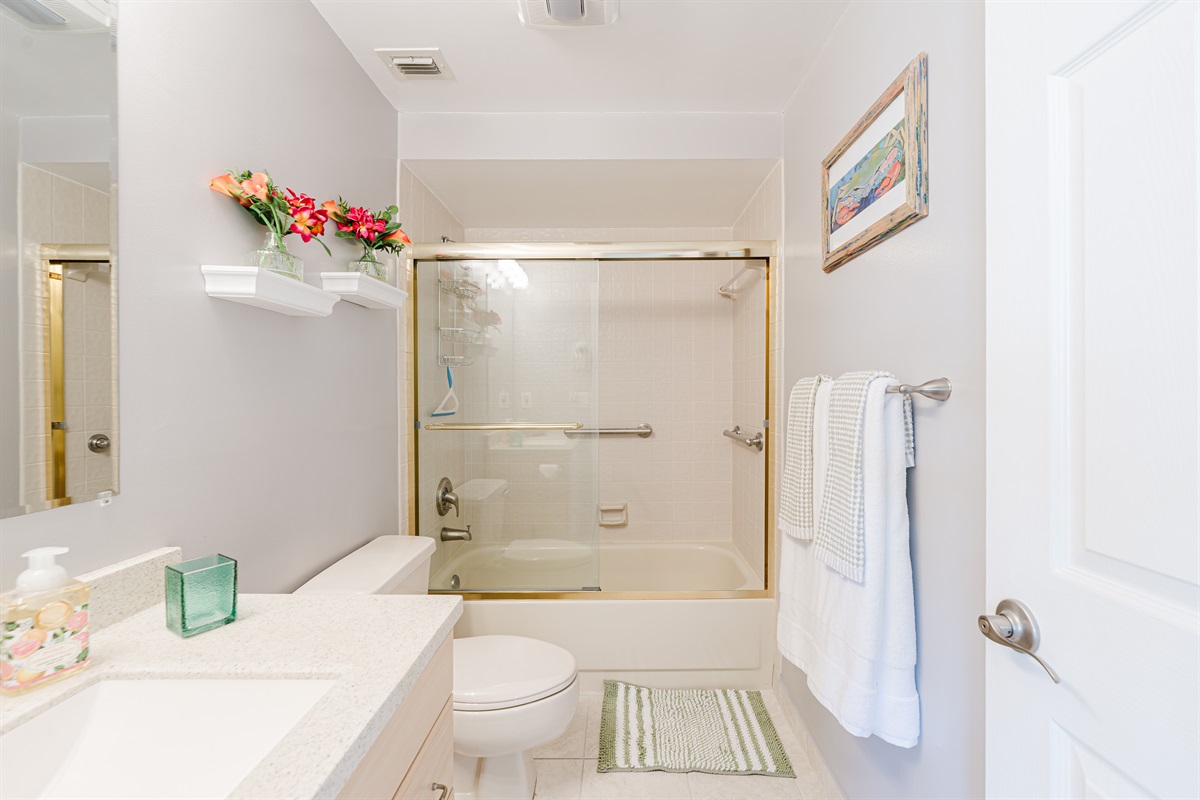 Clean and bright guest bathroom with tub/shower combo—perfect for families and longer stays
