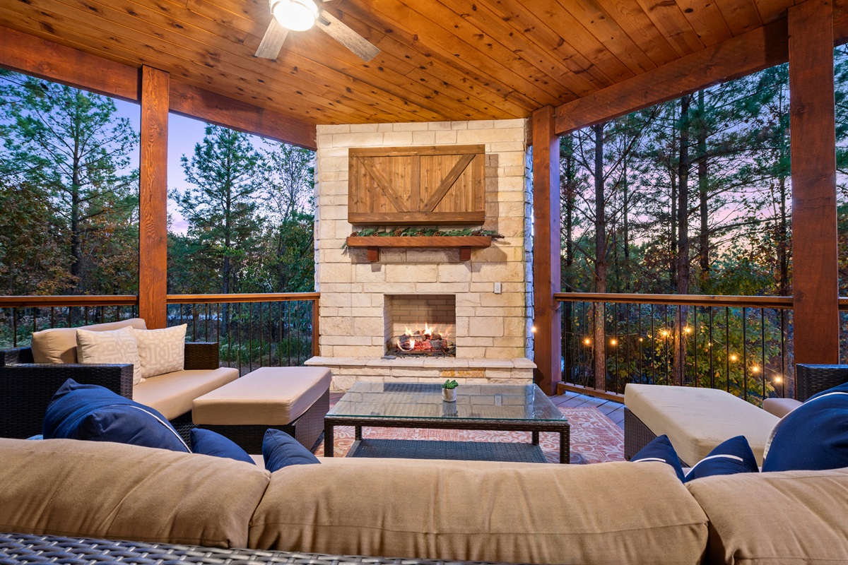 The outdoor fireplace and seating area provide the ultimate cozy setup for stargazing or curling up by the fire on cooler nights.