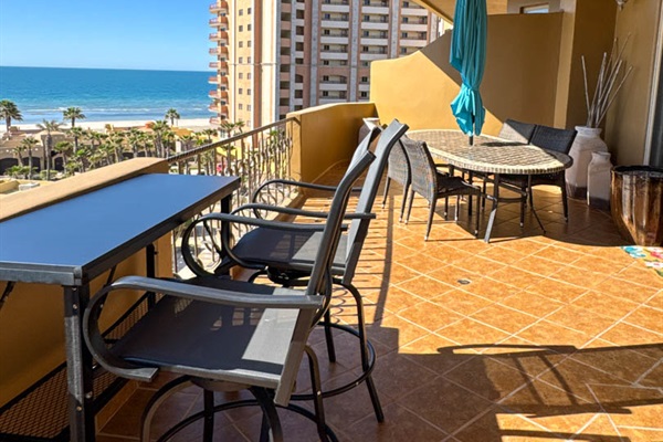 Relax on the patio with views of pools and the Sea of Cortez.