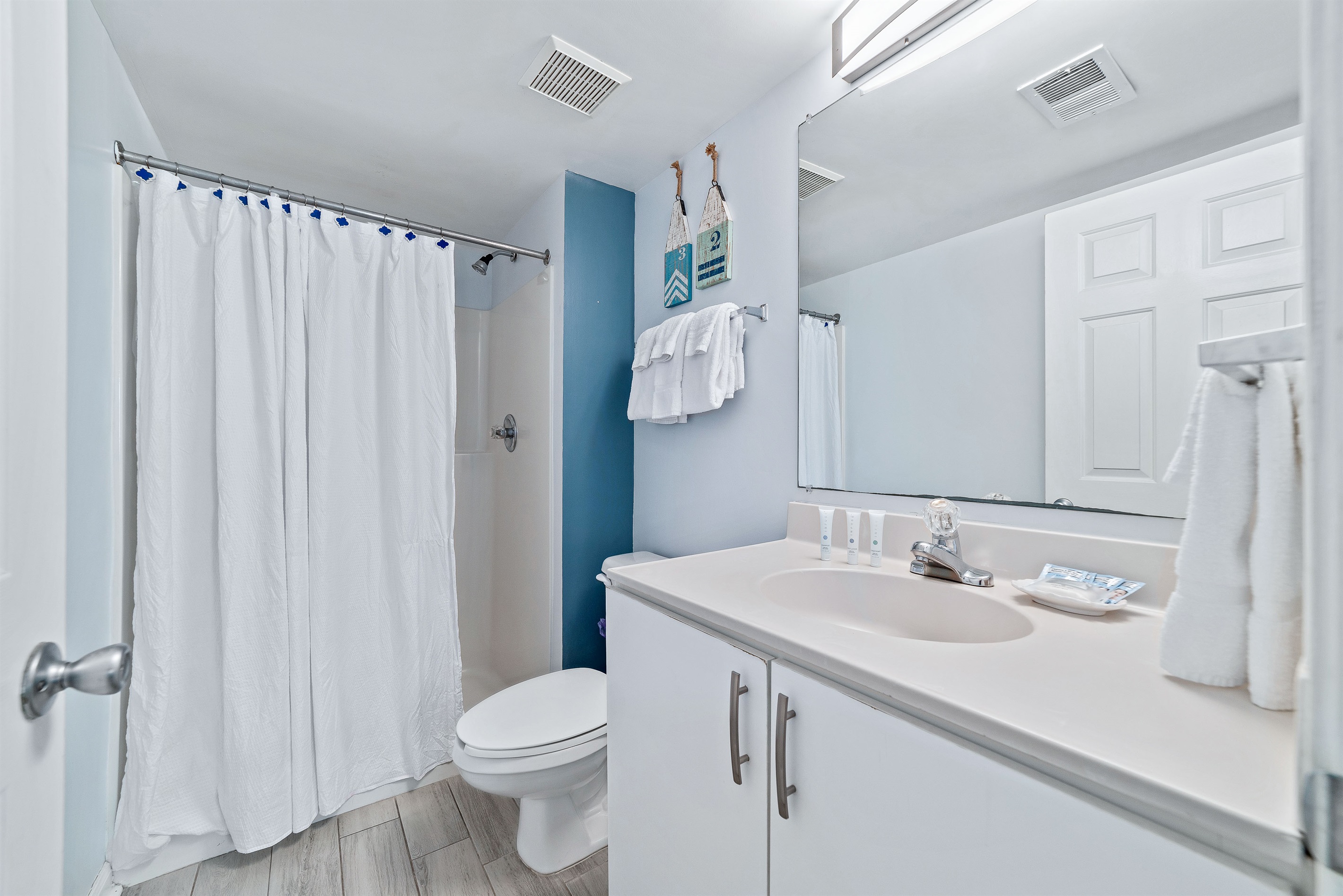 Guest Bathroom - This well-lit bathroom offers ample space and essential amenities.  A clean and inviting retreat.