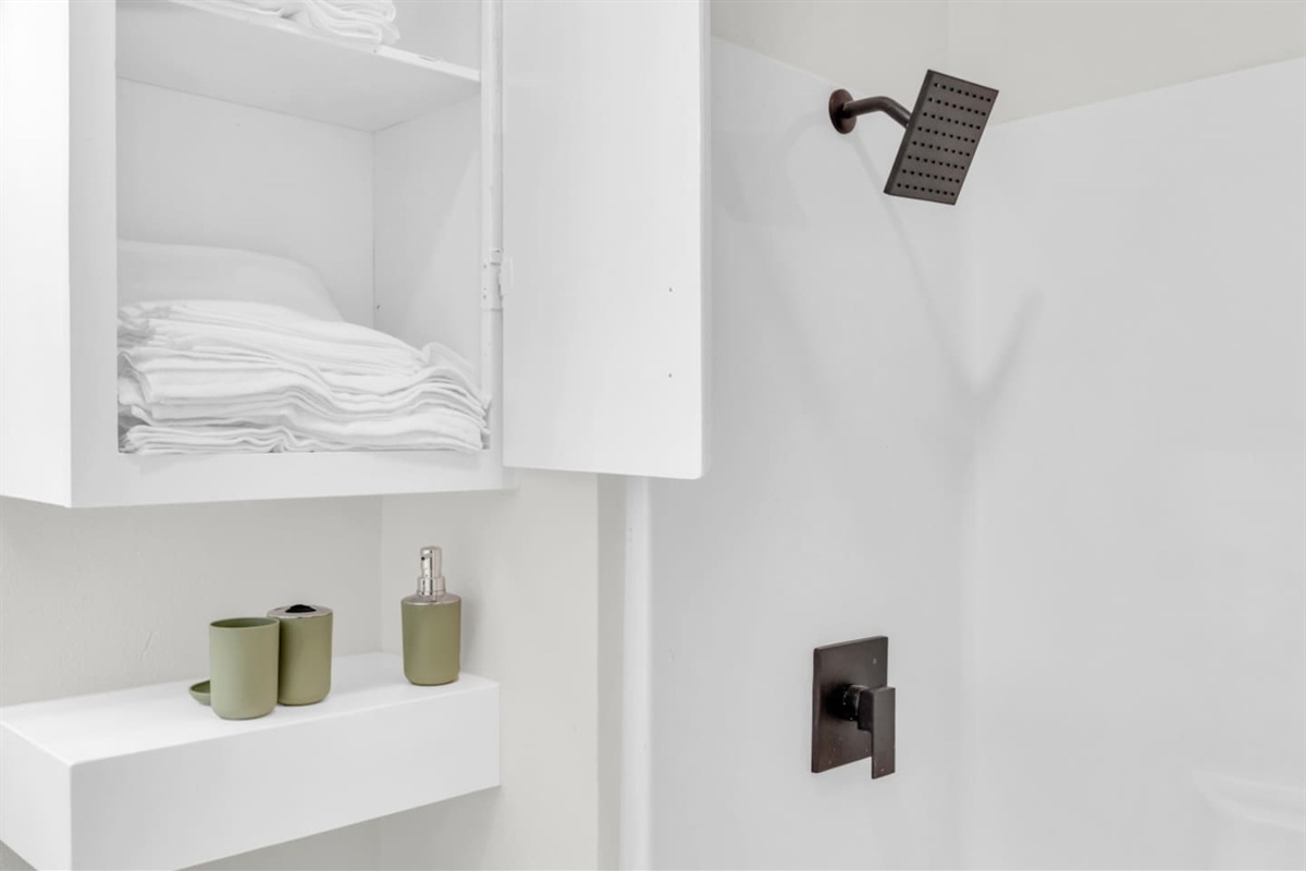 Bathroom with shower/tub combo and hotel-style touches.