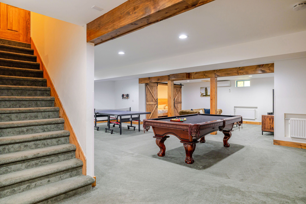 The lower-level game room offers hours of family fun with billiards, ping-pong, and plenty of space for gathering.