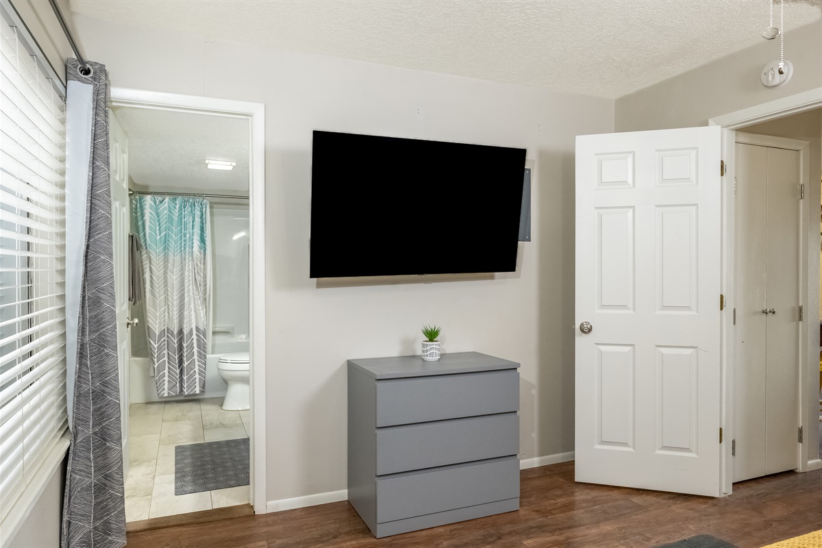 Bedroom with smart TV and ensuite bathroom.